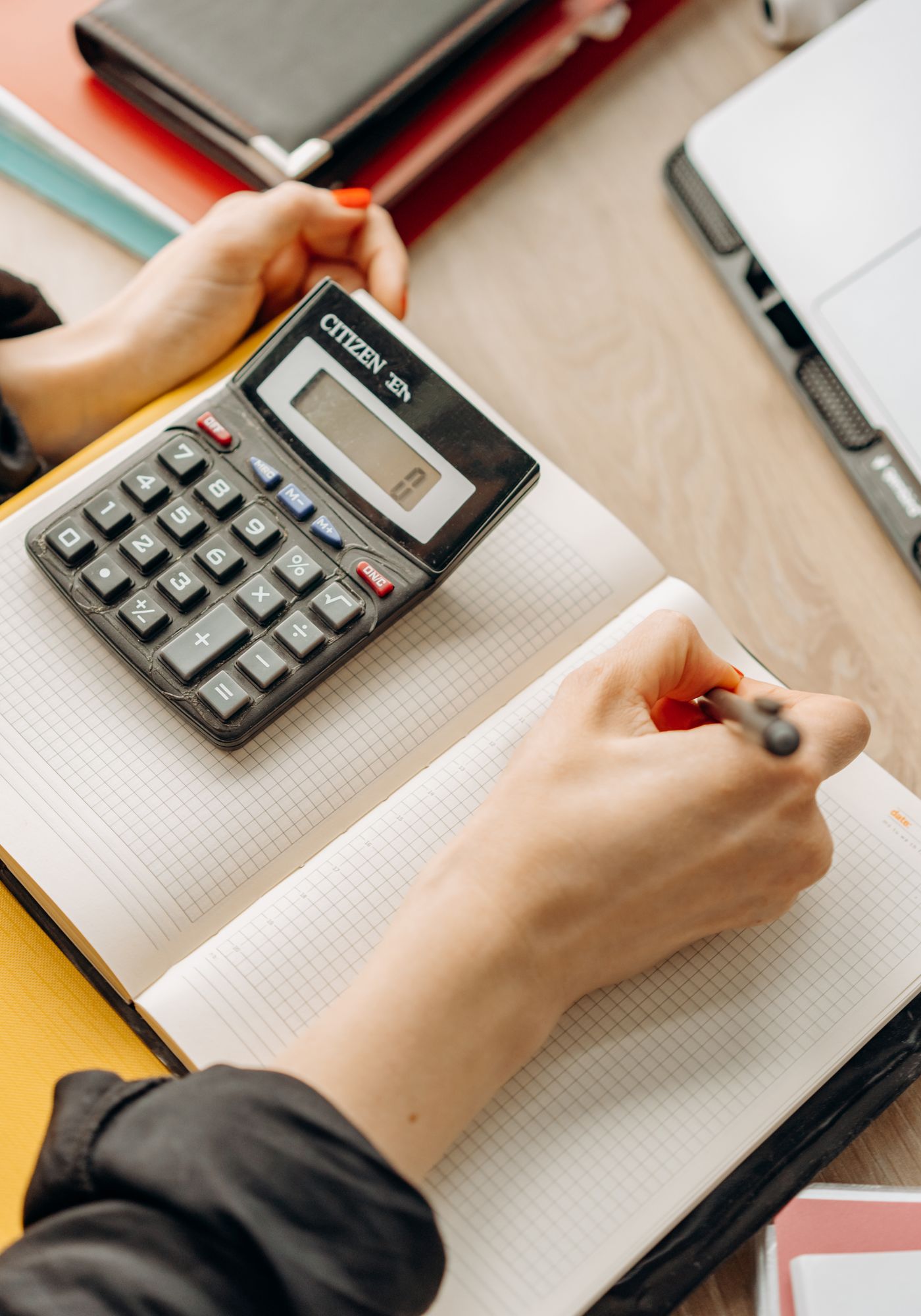 Defter ve hesap makinesiyle çalışan eller